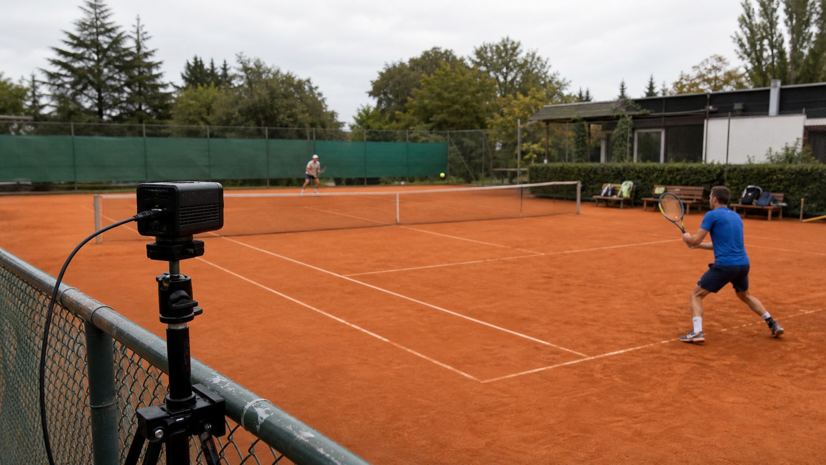 Illustrative camera setup recording a tennis rally on a clay court